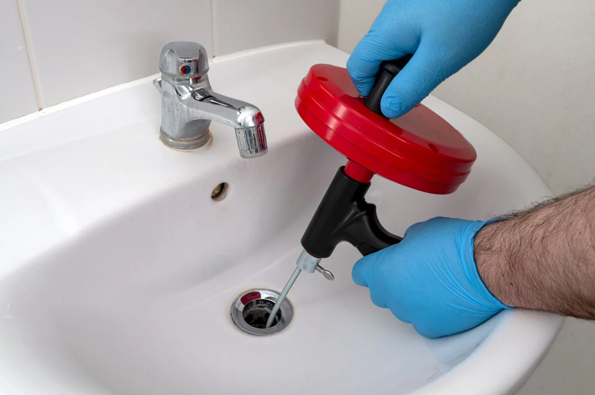 Drain snake used to clear a hair clog in a sink