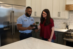 Technician talking about AC service pricing to homeowner