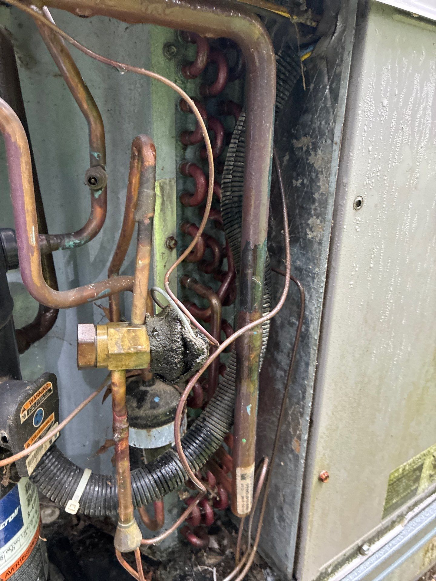 Paschal technician servicing the coil and refrigerant lines inside a Hot Springs, AR AC system