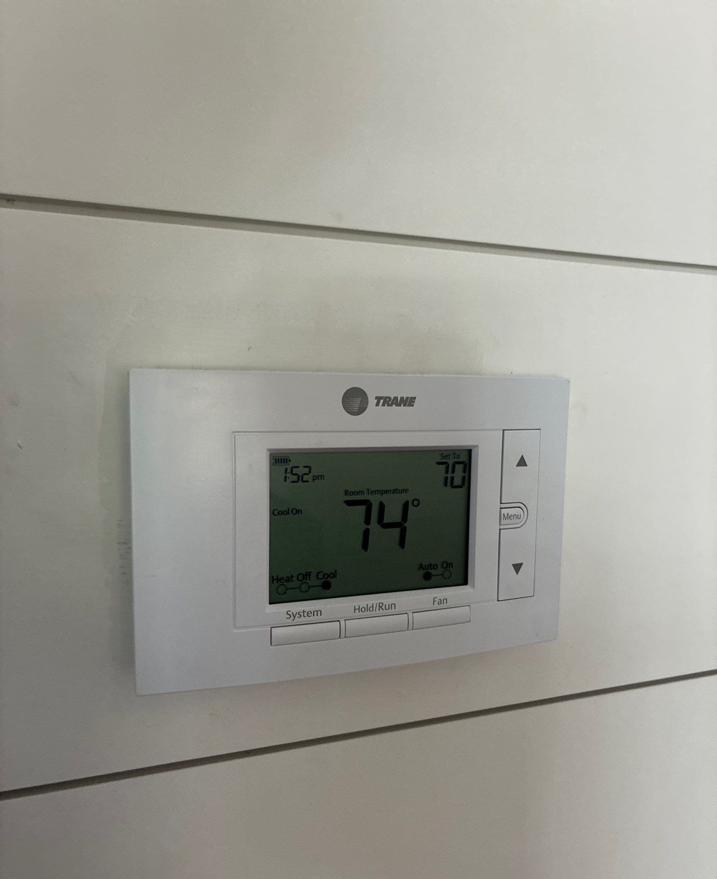 Paschal technician checking a home thermostat